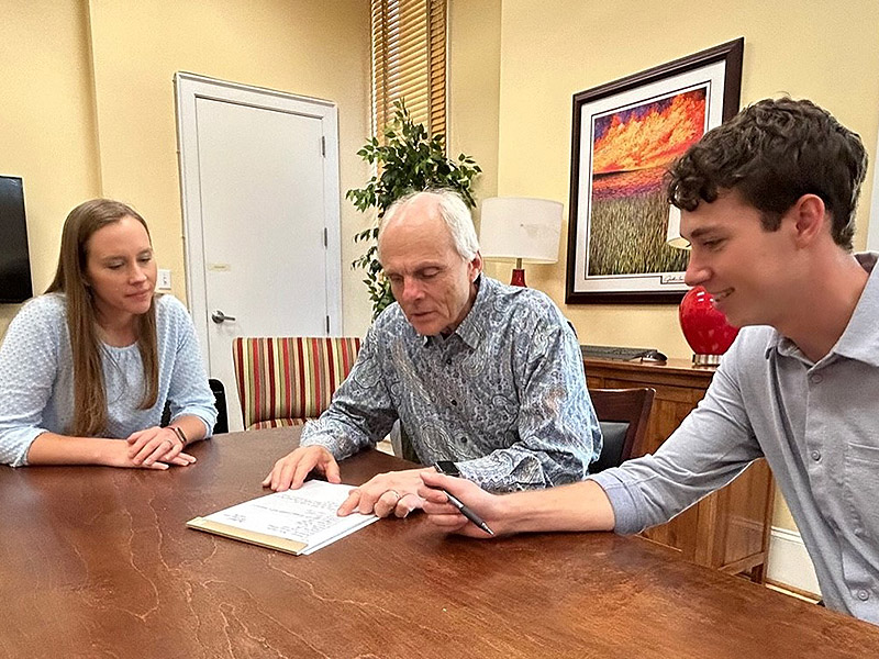 Detterbeck Wealth Management portrait of three team members discussing financial planning at Charleston office